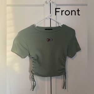 This beautiful cinched green sunflower shirt is from the brand Social Scene.